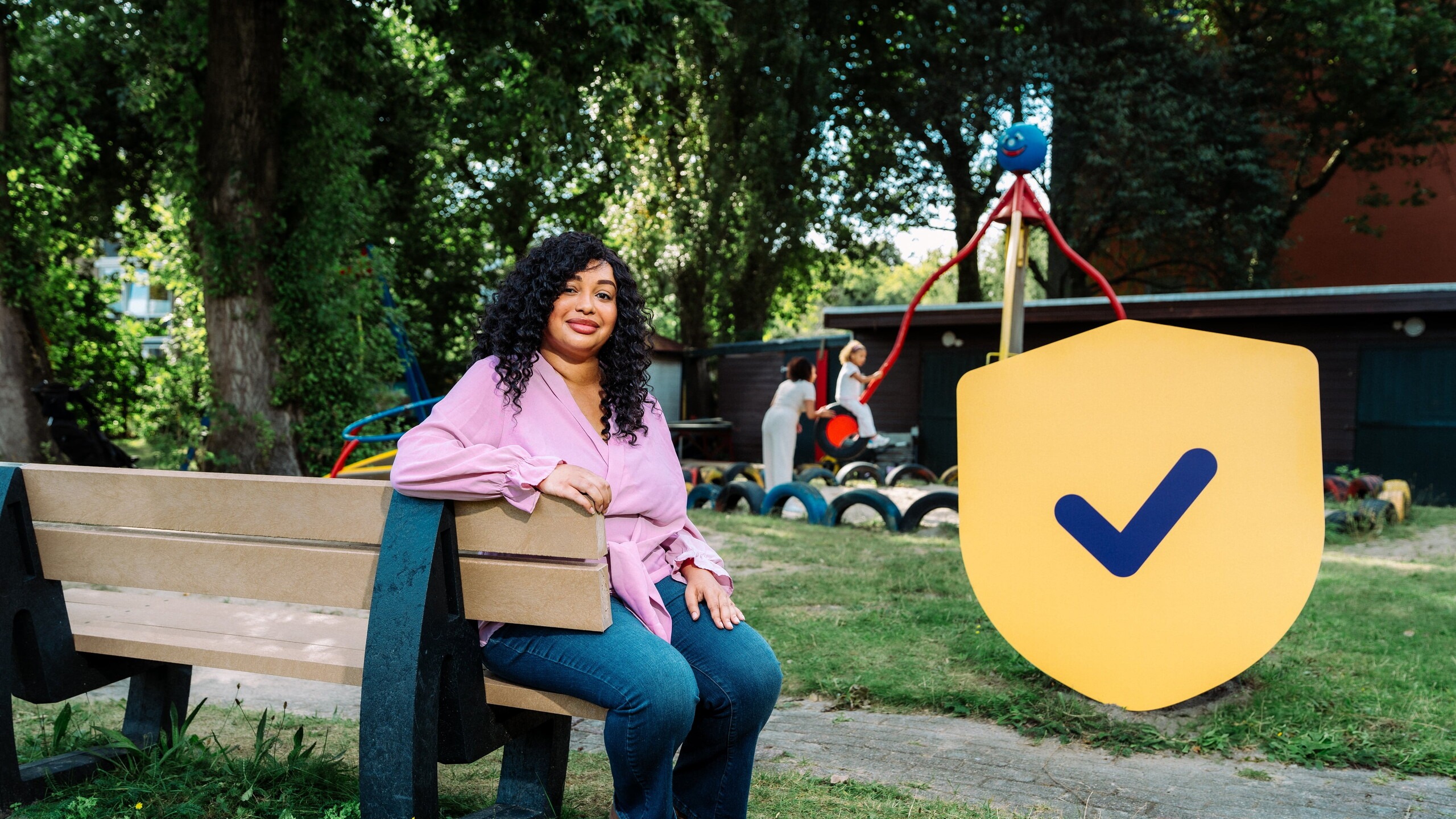 Vrouw in de speeltuin met Denk vooruit logo