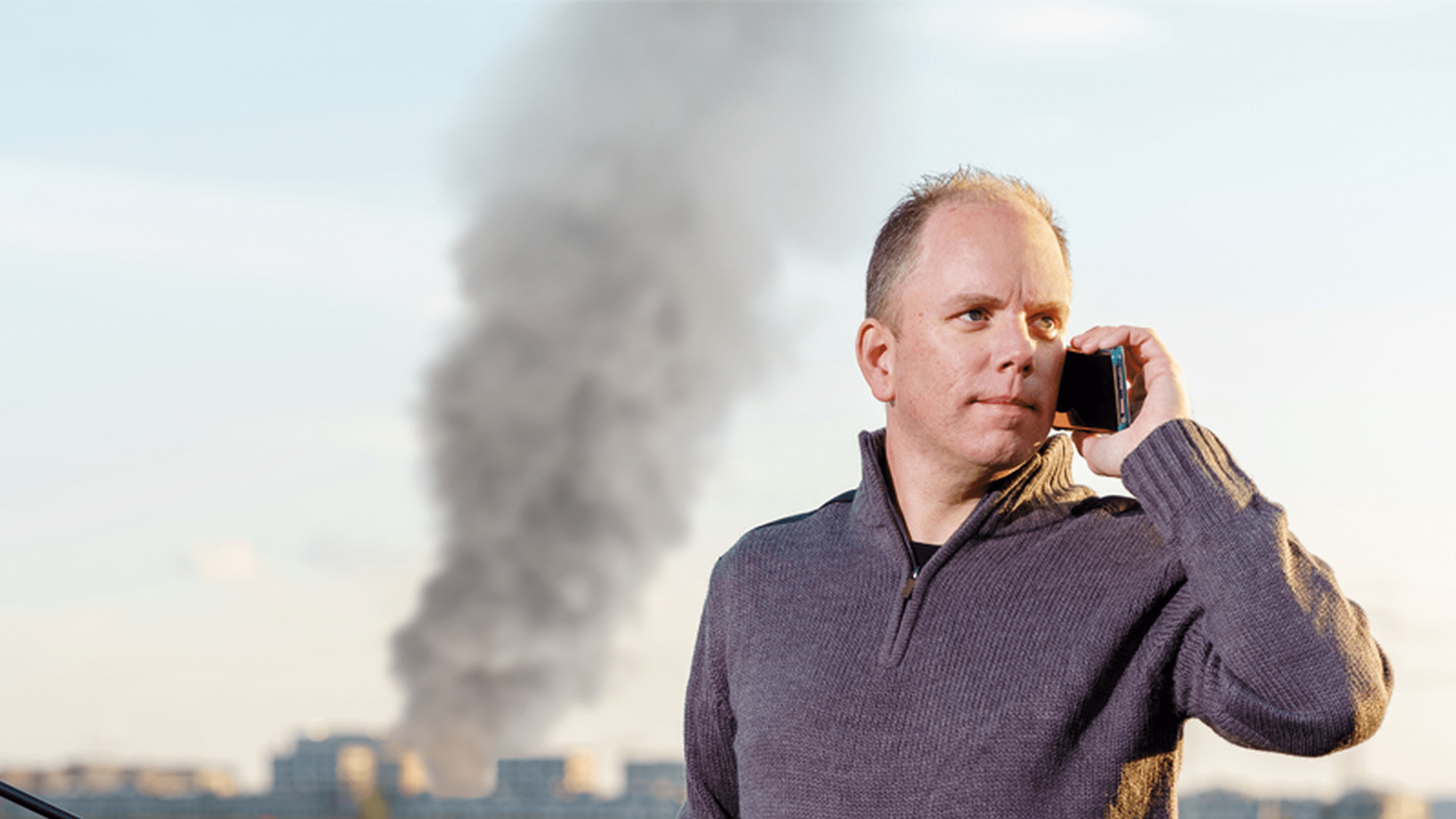 Visser belt rookwolk op de achtergrond